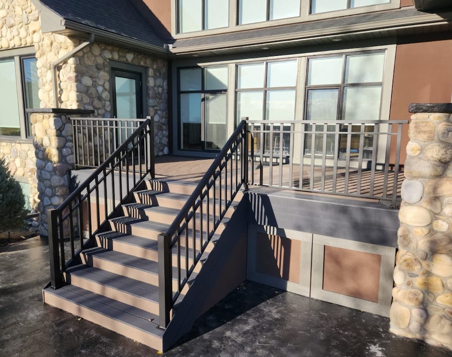 A custom deck and outdoor living space with a staircase