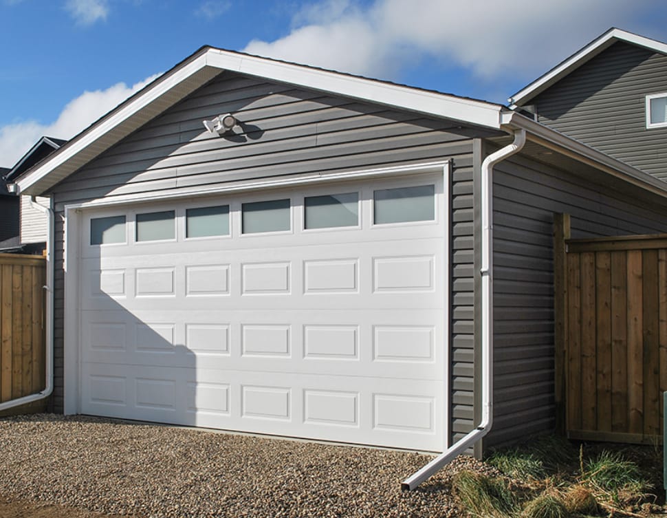 A detached garage and driveway on a Calgary property
