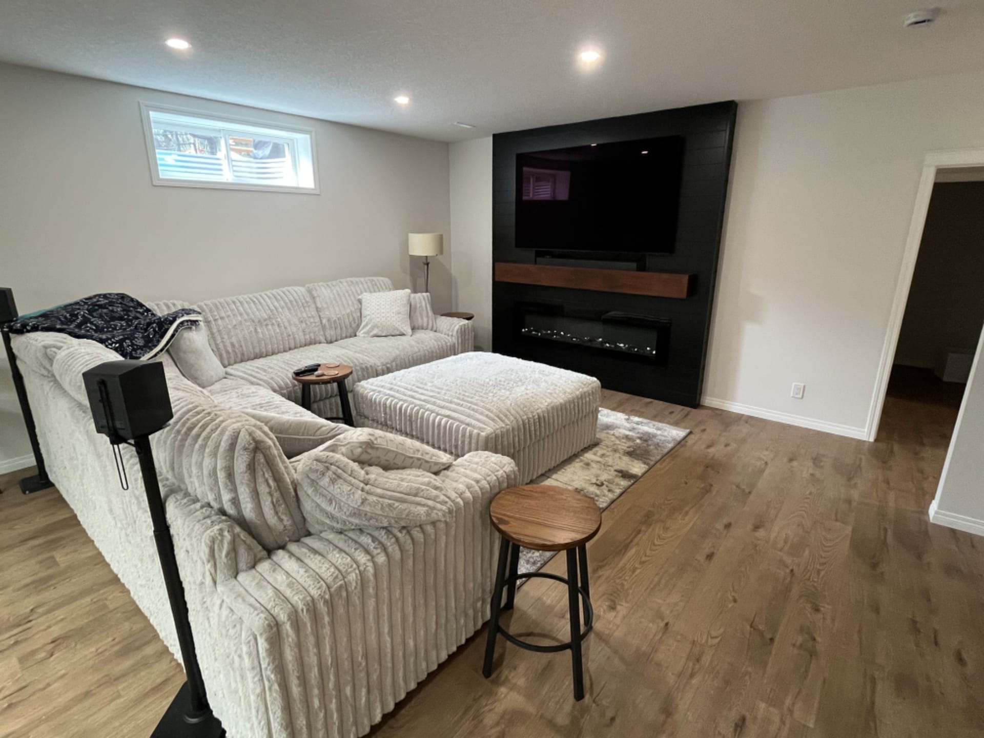 A renovated open-concept living room with a custom feature wall in a Calgary home